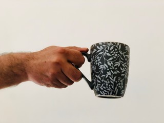 hand holding a cup of coffee 