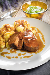 Braised pork neck in own sauce served with boiled potatoes.