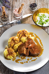 Braised pork neck in own sauce served with boiled potatoes.