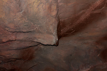 Dark stones in relief. The texture of the stone.