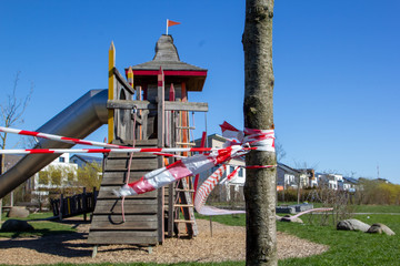 Fototapeta na wymiar Playground cordoned off because of the corona virus. German word Spielplatz means playground