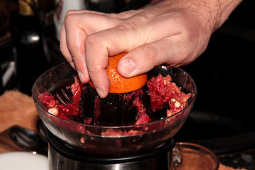 Juicer. The process of squeezing the juice from a citrus fruit.