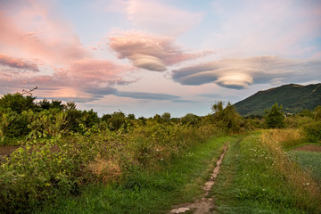 Amazing colorful lenticular clouds over mountain in countryside at the walking route. Irun, Basque Country, Spain. Camino de Santiago