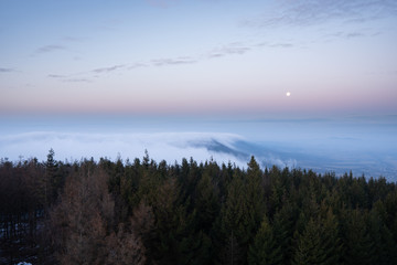 landscape in the mountains before sunrise in a cloud of fog
