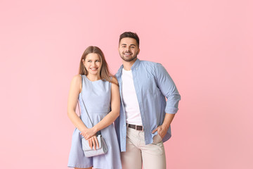 Happy young couple on color background