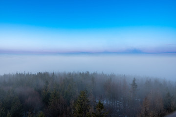 beautiful fog in mountains before sunrise with forest with moon, Czech Beskydy