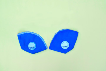 Two light blue pollution mask with rubber straps isolated on a white background