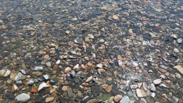 Crystal clear waters of a lake on stony shore in Patagonia Argentina