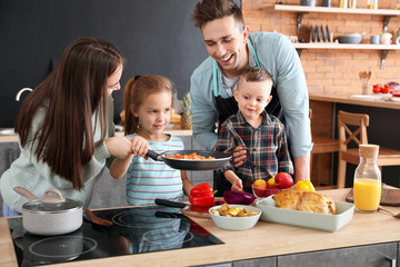 Young family cooking together in kitchen