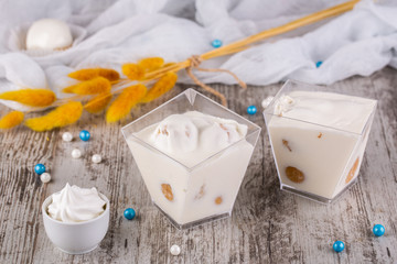 Fototapeta na wymiar Profitroli in vanilla mousse with cream and beads