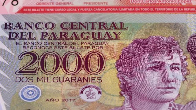Paraguay guarani notes tracking. Paraguayan currency. Slider shot. Low angle, 4K