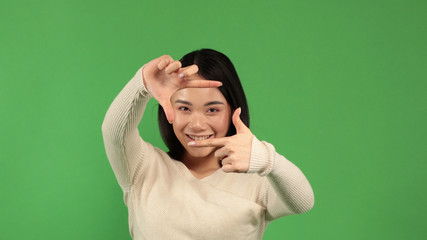 Smiling asian business woman making frame with fingers, attractive young asian happy woman