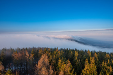Fototapeta na wymiar Beautifully lit fog at sunrise in the mountains, Czech Beskydy