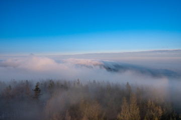 Fototapeta na wymiar fog rolling in the mountains over the hills at sunrise, Czech Beskydy