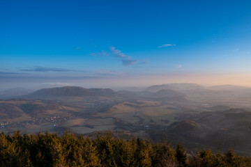 beautiful czech landscape in mountains at sunrise with fog in valley at the turn of winter and spring, czech beskydy