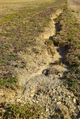 Field erosion of soil on grass surface damage
