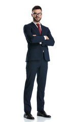 businessman standing with arms crossed to chest and posing happy