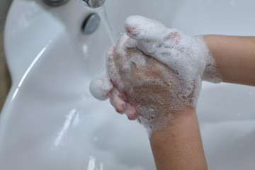 Washing hands rubbing with soap kid for coronavirus protection.