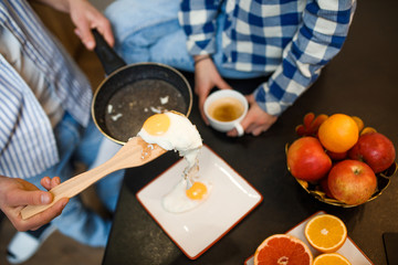 Cropped image, male cooking omelette, morning breakfast at the kitchen