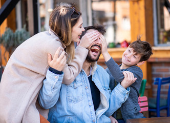 A family outside, laughing and spending their time together.