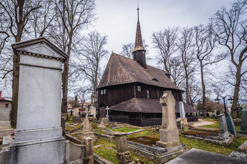 Rear view of historic wooden Church of Virgin Mary on a cemetery in Broumov city, Czech Republic