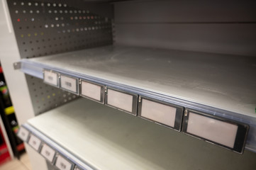 Sold out - empty shelves in grocery store caused by coronavirus panic
