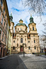 Fototapeta na wymiar Prague, Czech republic - March 19, 2020. St. Nicholas Church in Old Town Square during coronavirus crisis and travel ban