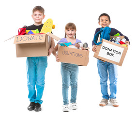 Little children with donations on white background