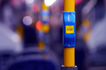 Yellow stop button for bus or tram. Press the button to request the bus driver for get off at the...