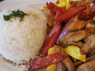 Exquisite Peruvian food with tomato and salted chicken
