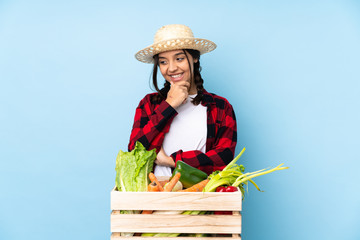 Young farmer Woman holding fresh vegetables in a wooden basket looking to the side