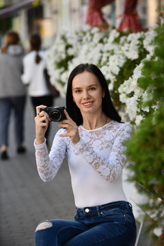 Young woman photographer with digital camera 