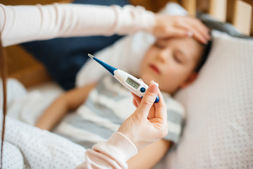 Thermometer close- up during the child's illness . The virus and the epidemic