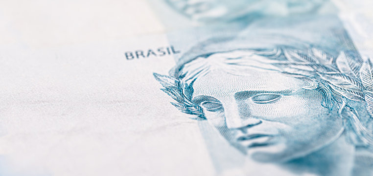 details of 100 reais banknote from brazil, with selective focus, background image for monetary concept. Financial crisis or financial business in brazil.