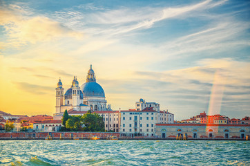 Fototapeta premium Santa Maria della Salute Roman Catholic church and Punta della Dogana, Venice historical city centre, promenade waterfront of Giudecca Canal, Veneto Region, Italy. Venice cityscape amazing sunset