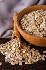 raw oatmeal on a wooden rustic background