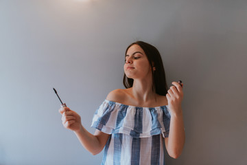 Fototapeta premium A beautiful caucasian teenage girl makes up in her room