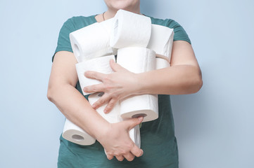 woman holds many rolls of toilet paper in the toilet. excitement, greed, panic
