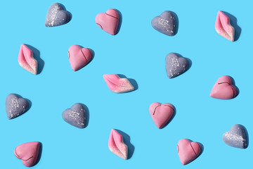 Sweet chocolate candies on a blue background, hard shadow, geometric seamless pattern, flat lay, layout for design.