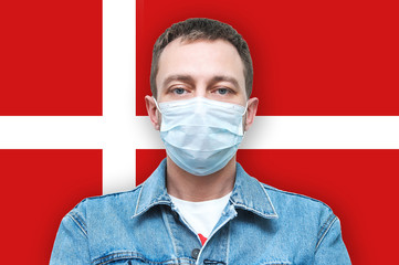Man in a denim jacket and medical breathing mask. masked man on a white background