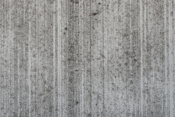 Concrete wall with rough structure, grey and weathered in high detail