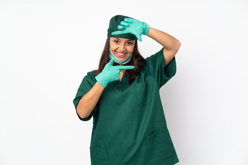 Surgeon woman in green uniform isolated on white background focusing face. Framing symbol