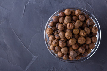 fresh spicy peppers allspice on a dark stone background