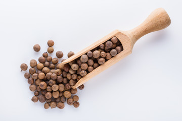 fresh spicy peppers allspice on white acrylic background