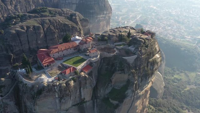Aerial view of monastery Trinity and breathtaking pictures of valley and landmark canyon of Meteora at sunset, Kalambaka, Greece, shadows, twisted road, bridge, Mountains as columns