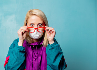 Style blonde woman in 90s clothes and face mask
