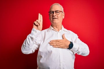 Middle age handsome hoary man wearing casual shirt and glasses over red background smiling swearing...