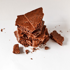 Chocolate on a white background, isolated. Porous Chocolate Texture