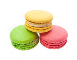 three macaroons, pink, yellow, green on a white isolated background