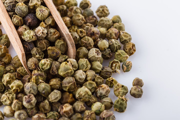 spicy green peppers on white acrylic background